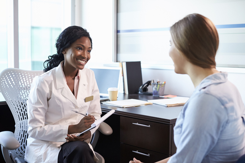 Doctor in consultation with female patient in office